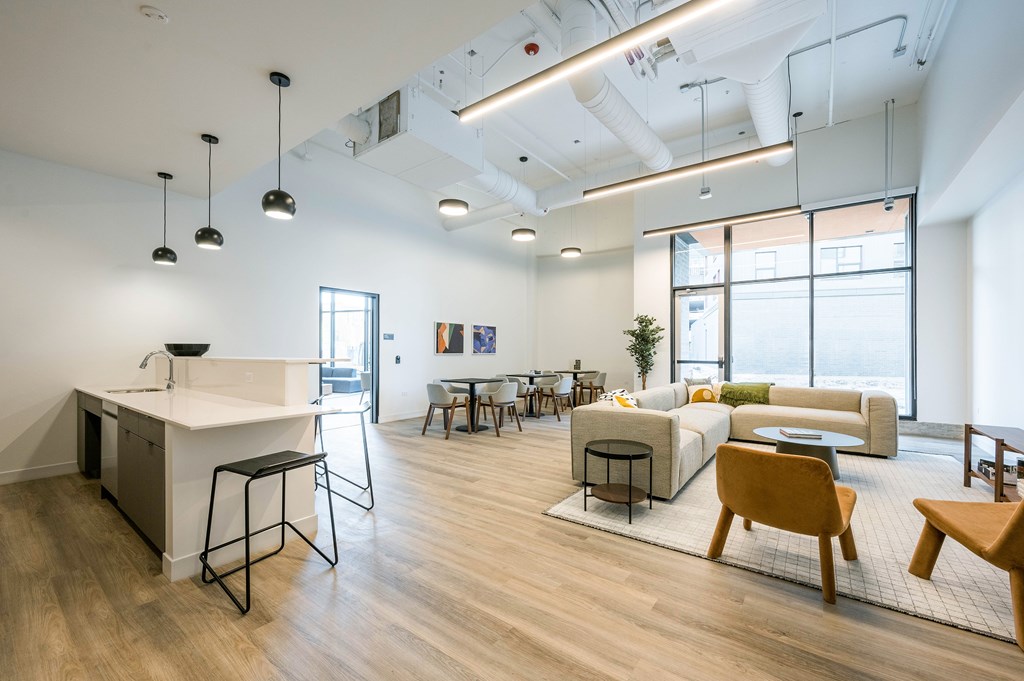 A modern office space with a kitchen area and seating.