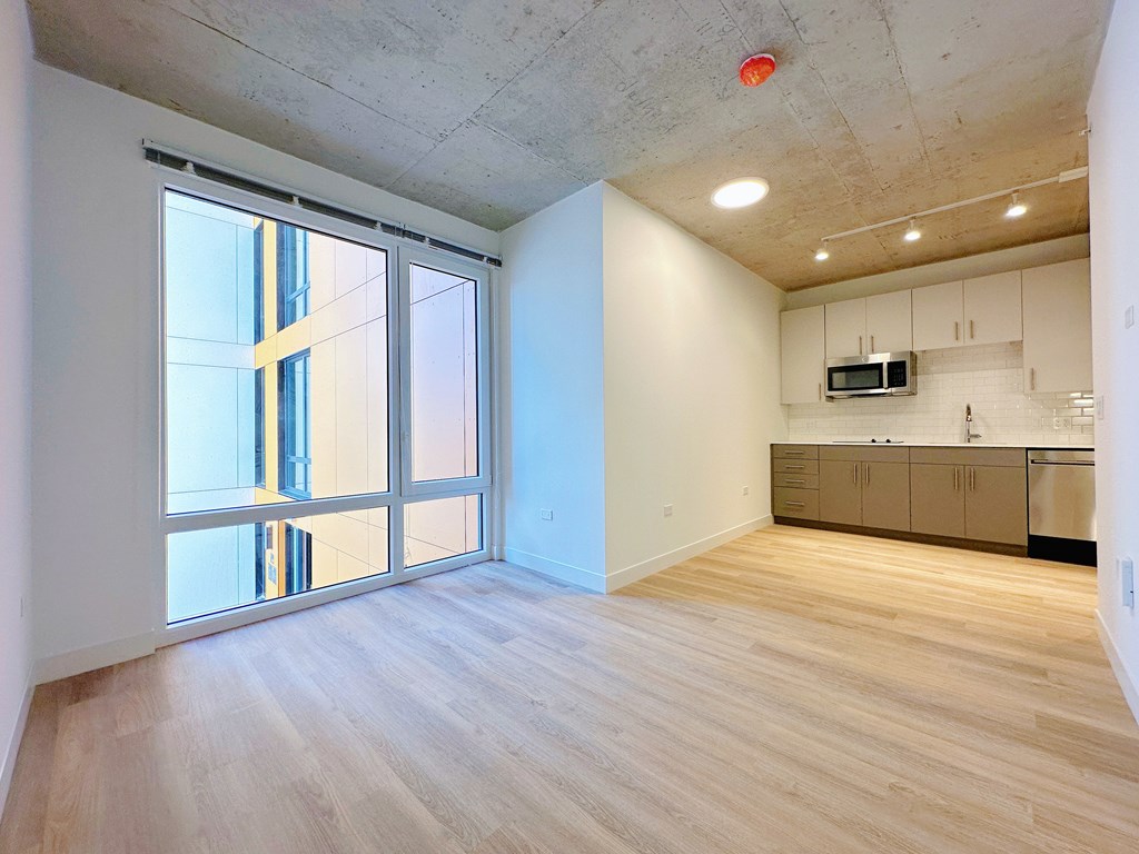 A kitchen area with a microwave and a refrigerator.