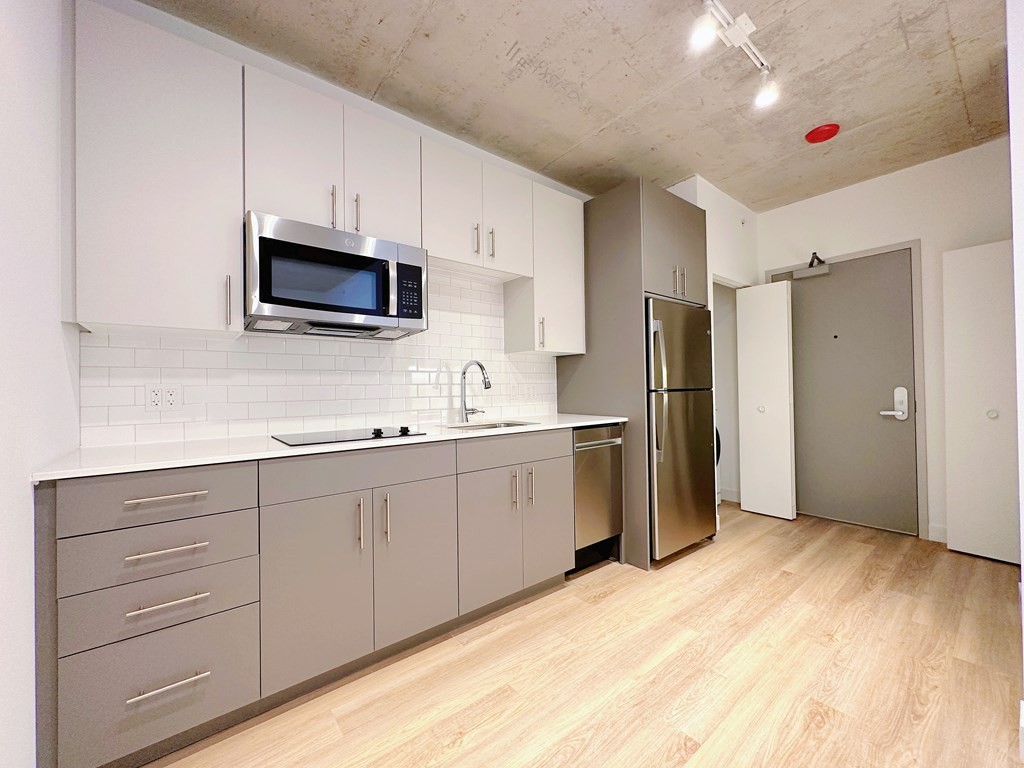 A kitchen with a microwave above the sink.