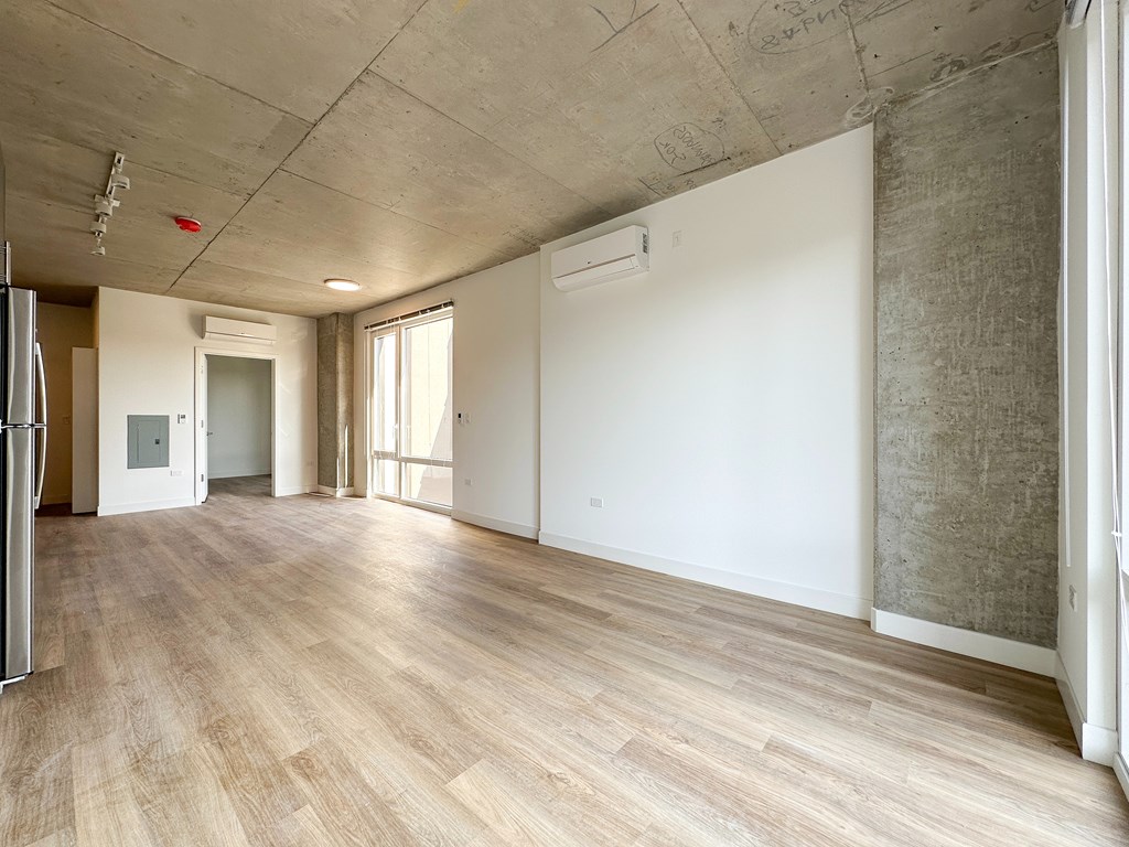 A room with wooden floors and a white wall.