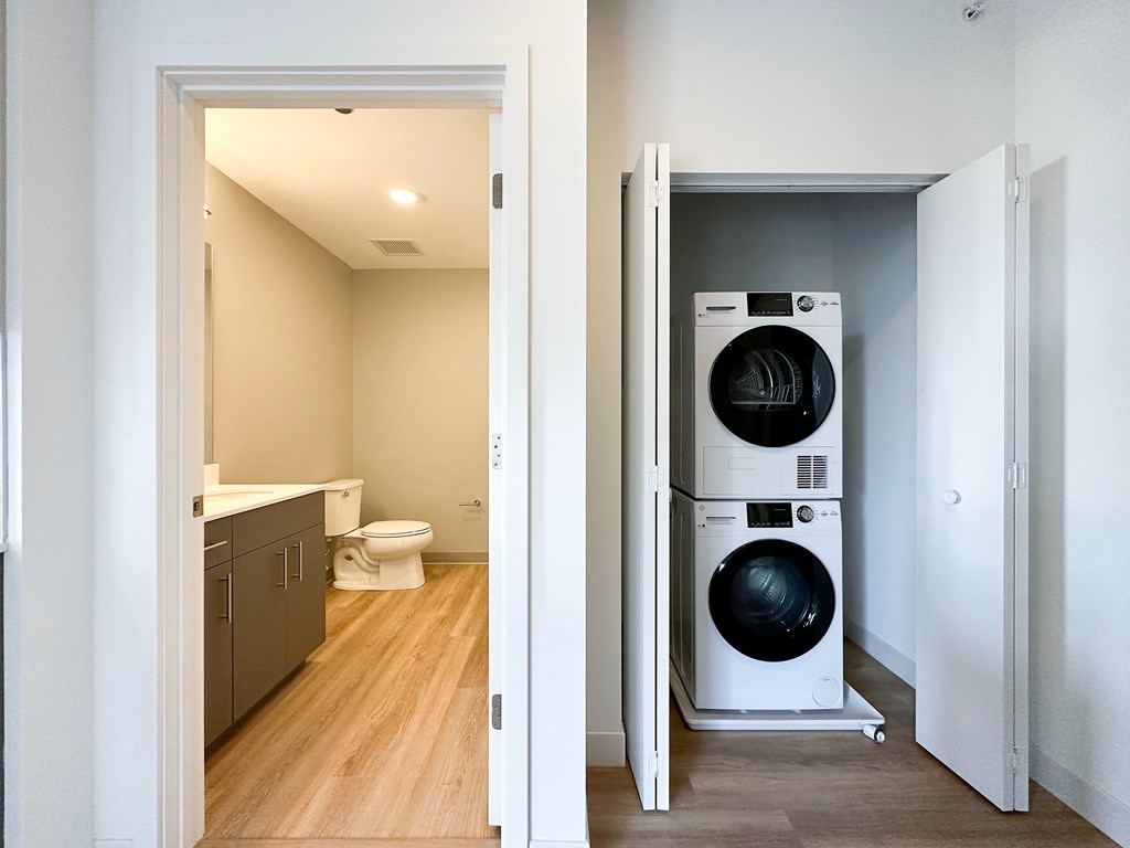 A white washing machine is in a small room.