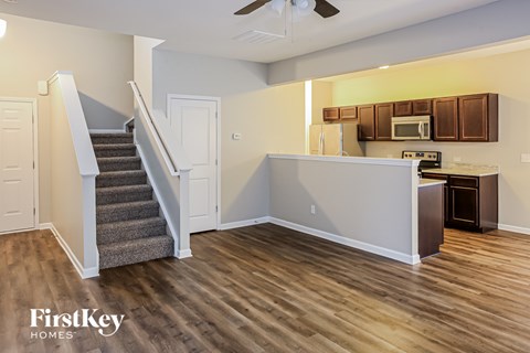 A kitchen area with a staircase leading to the upper floor.