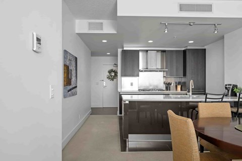 A modern kitchen with a dining table and chairs.