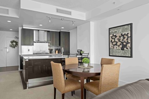 A modern kitchen with a dining table and chairs.