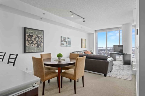 A dining room with a table and chairs.