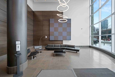 A modern waiting area with a large abstract painting on the wall.