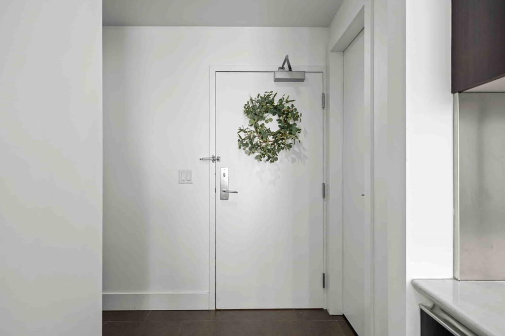 A white door with a wreath on it.