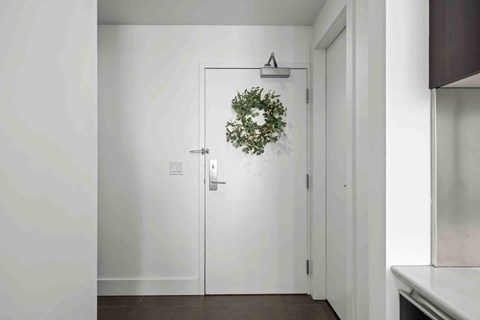 A white door with a wreath on it.