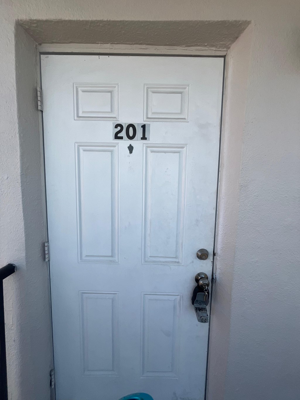 A white door with the number 201 on it.