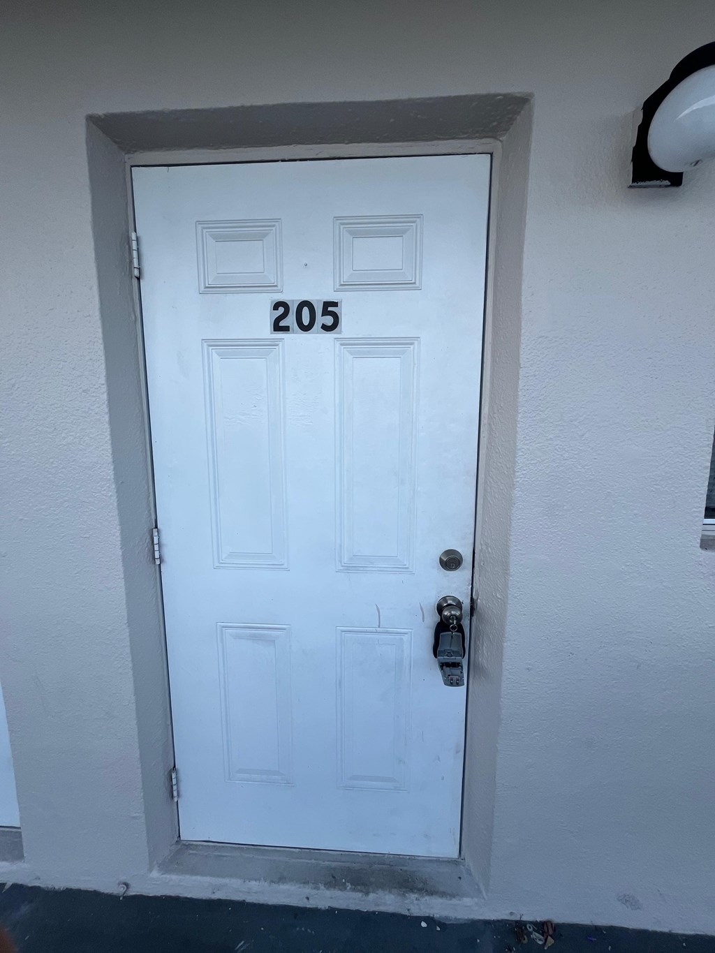 A white door with the number 205 on it.