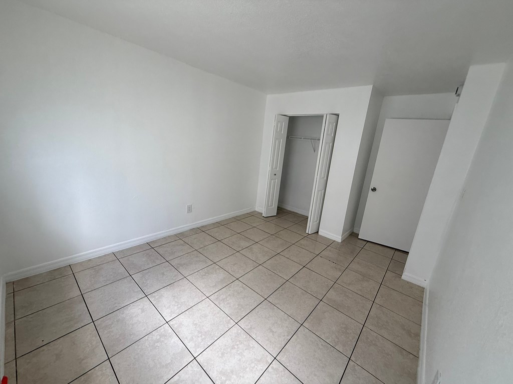 A room with white walls and a tiled floor.