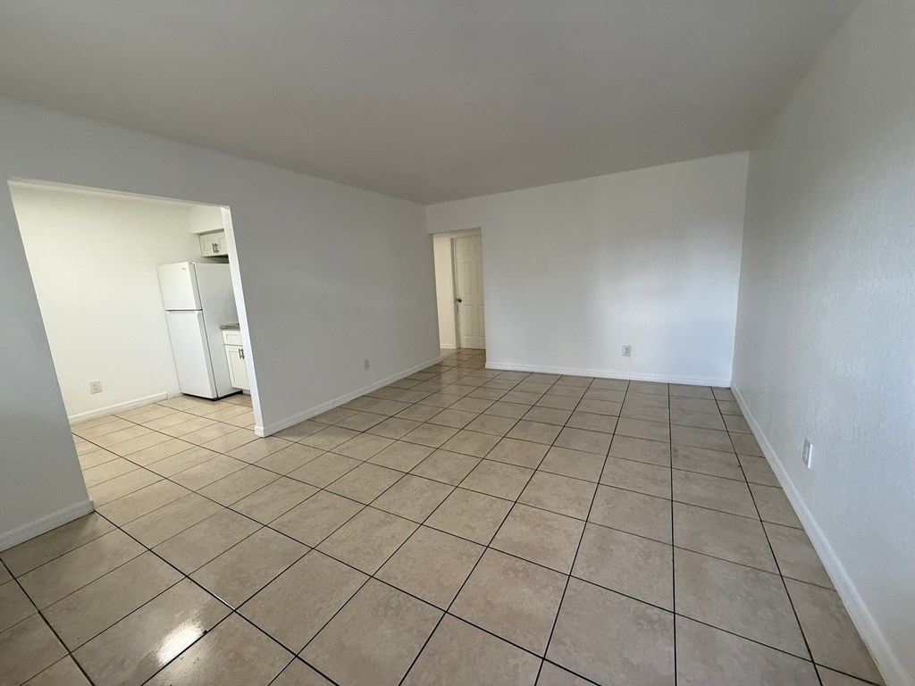 Empty room with tiled floor and white walls.