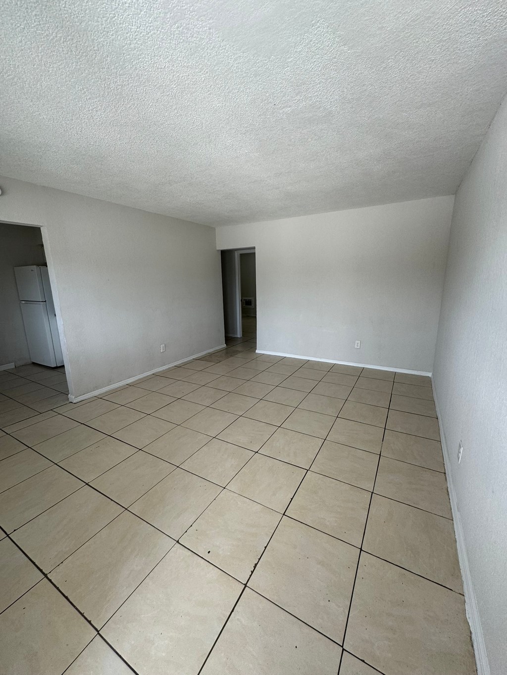 A room with a tiled floor and a closet.