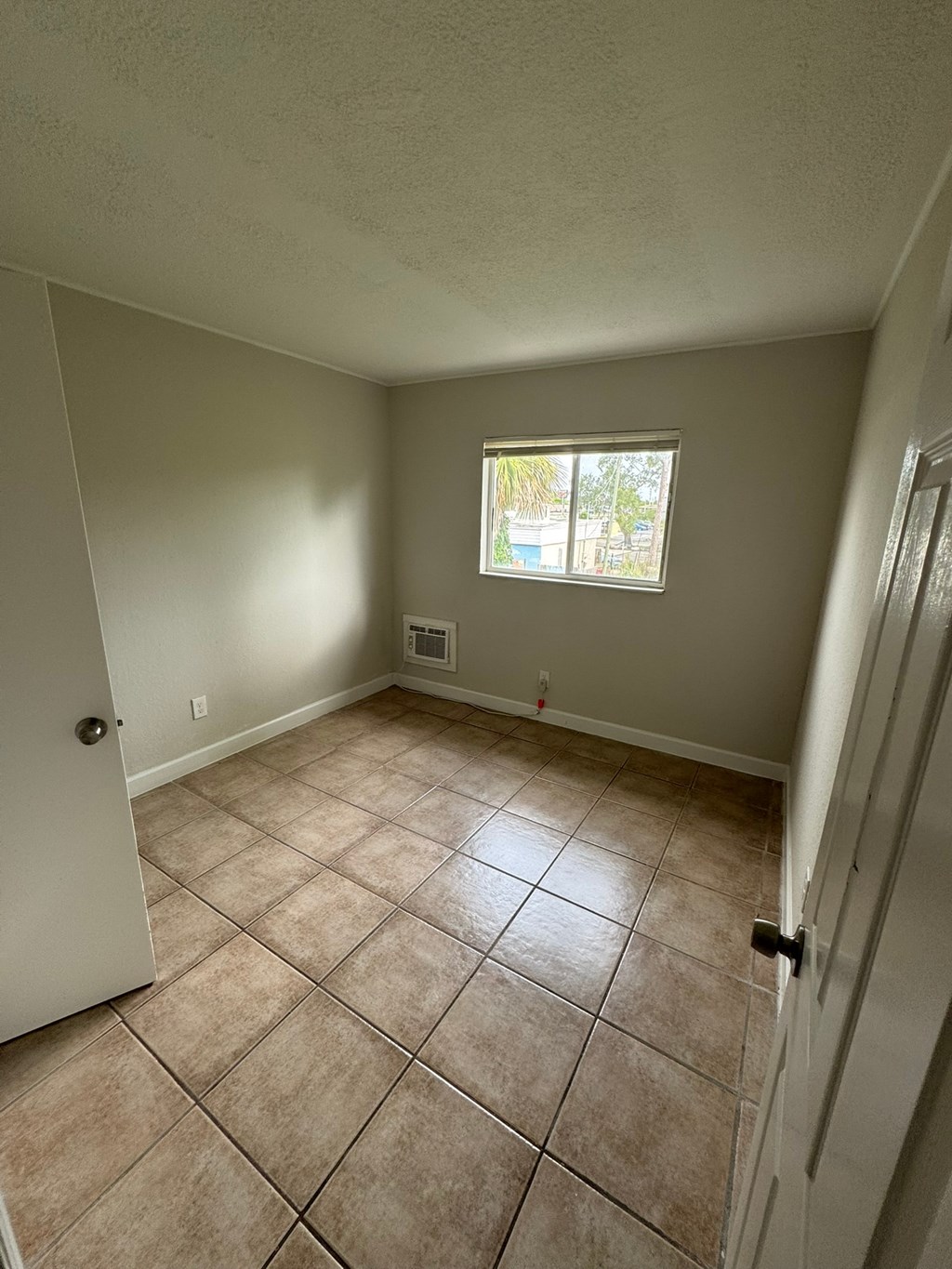 A room with a tile floor and a window.