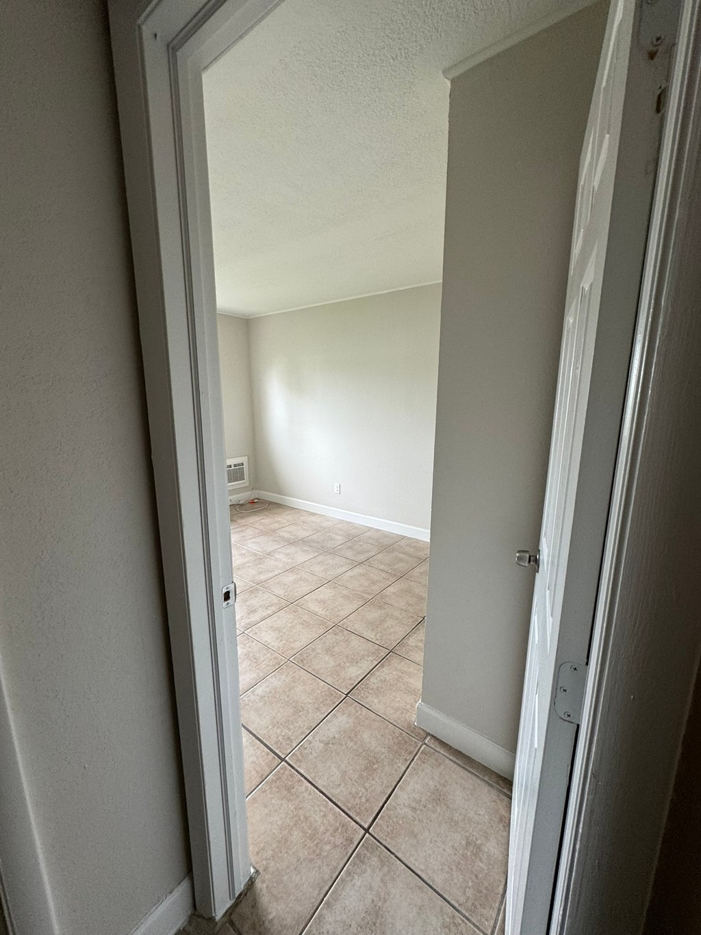 A room with a tiled floor and white walls.