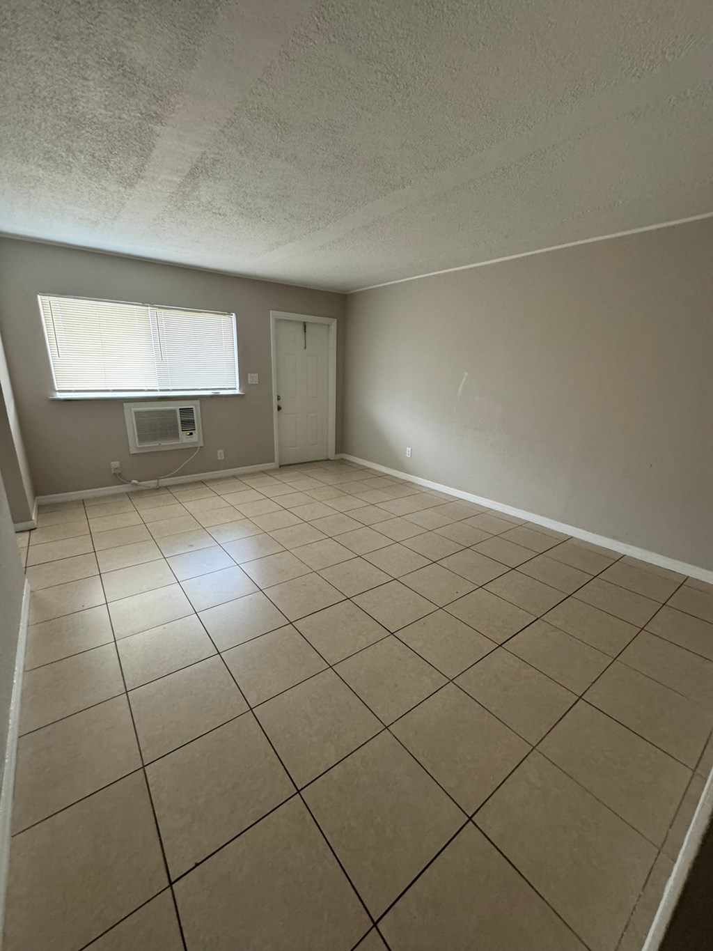 A room with a window and a door.