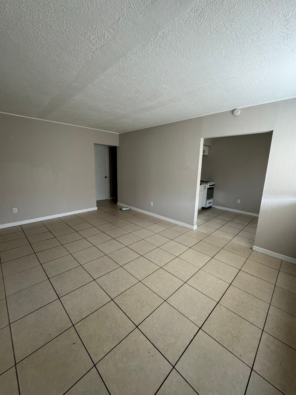 A room with a tile floor and a closet.