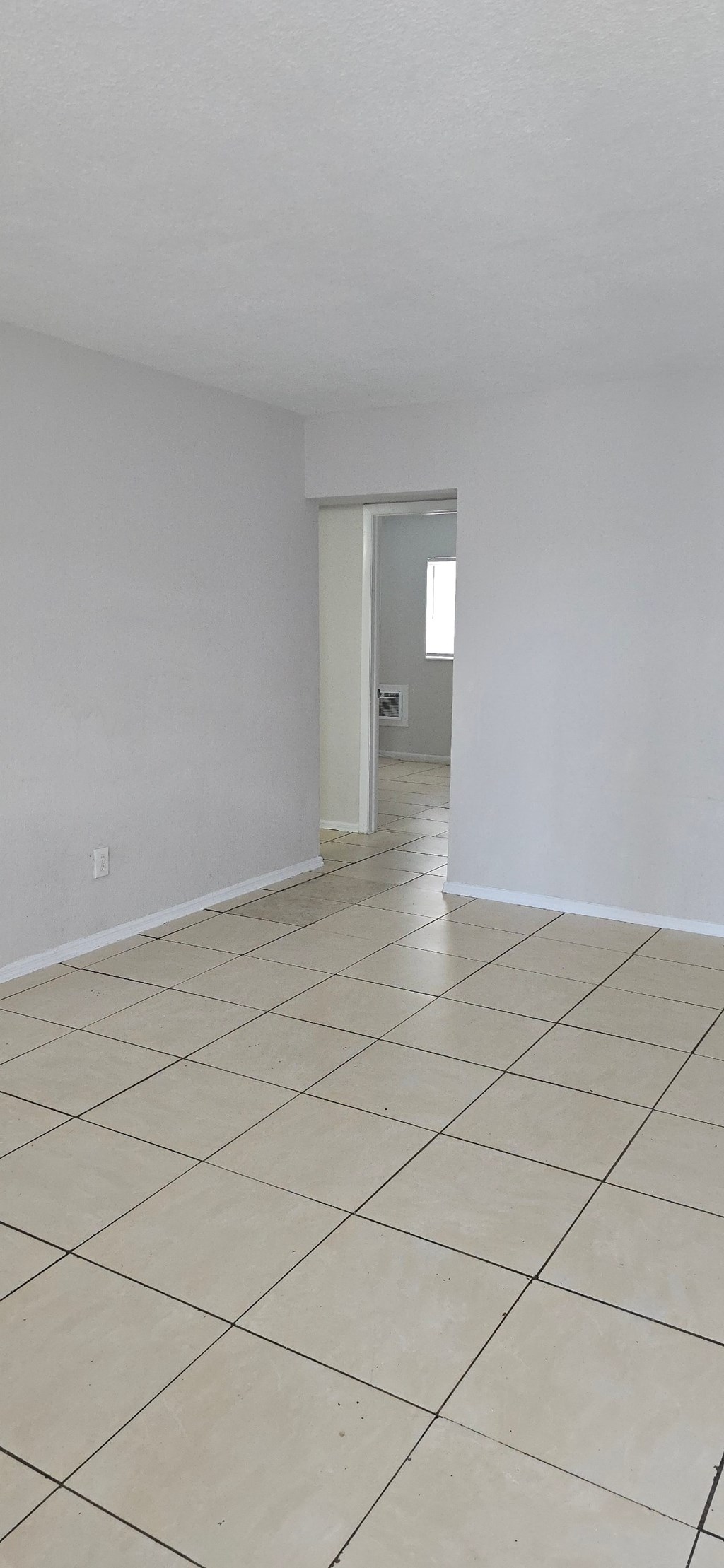 A room with white walls and a tiled floor.