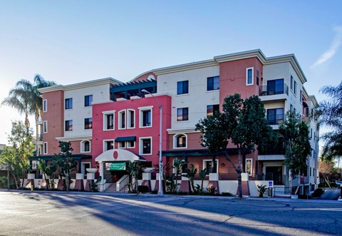 A multi-story building with a pink and beige facade.