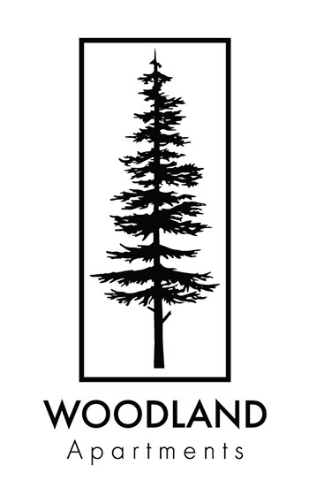 A black and white image of a tree is framed in a rectangle and labeled "WOODLAND Apartments".