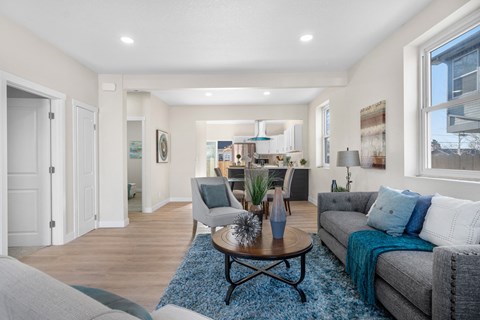 A living room with a grey couch and a coffee table.