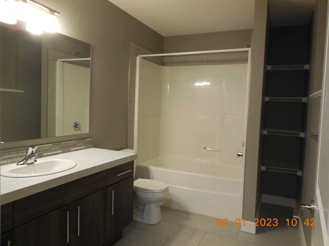 A bathroom with a toilet, sink, and bathtub.