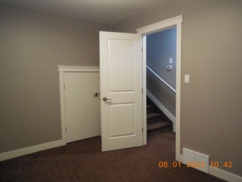 A white door is open to a hallway.