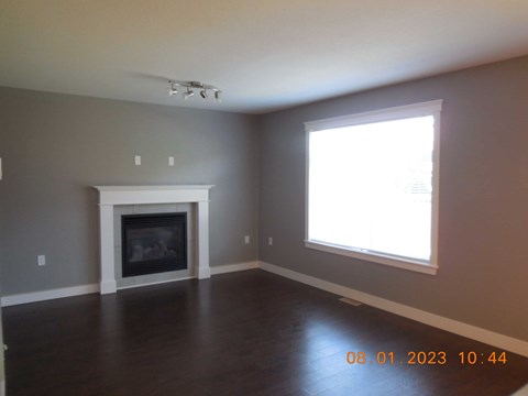 A room with a fireplace and a window.