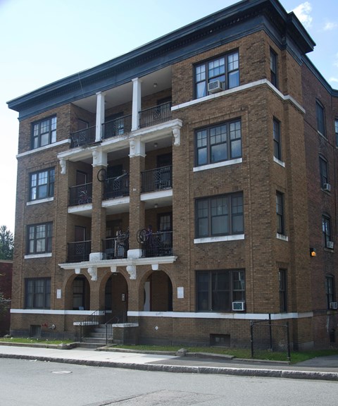 A large brick building with a balcony on the second floor.