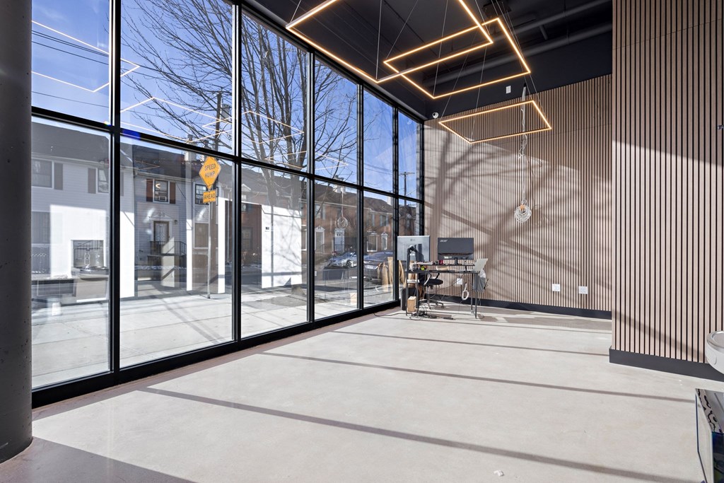 A view of a sunny day through a window with a yellow sign.