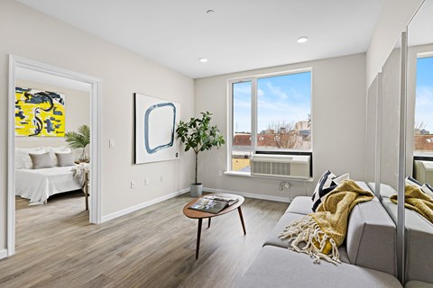 A living room with a grey couch and a coffee table.
