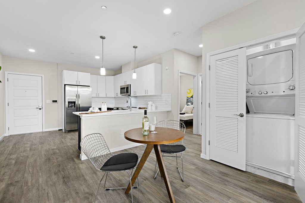 A modern kitchen with a dining table and chairs.