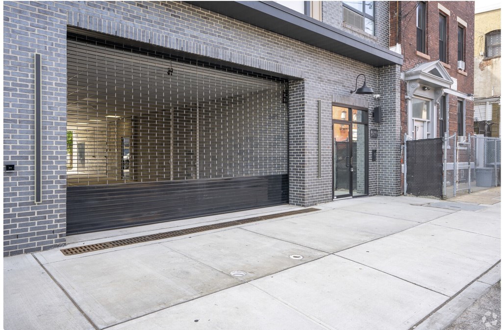 A brick building with a glass door and a black awning.