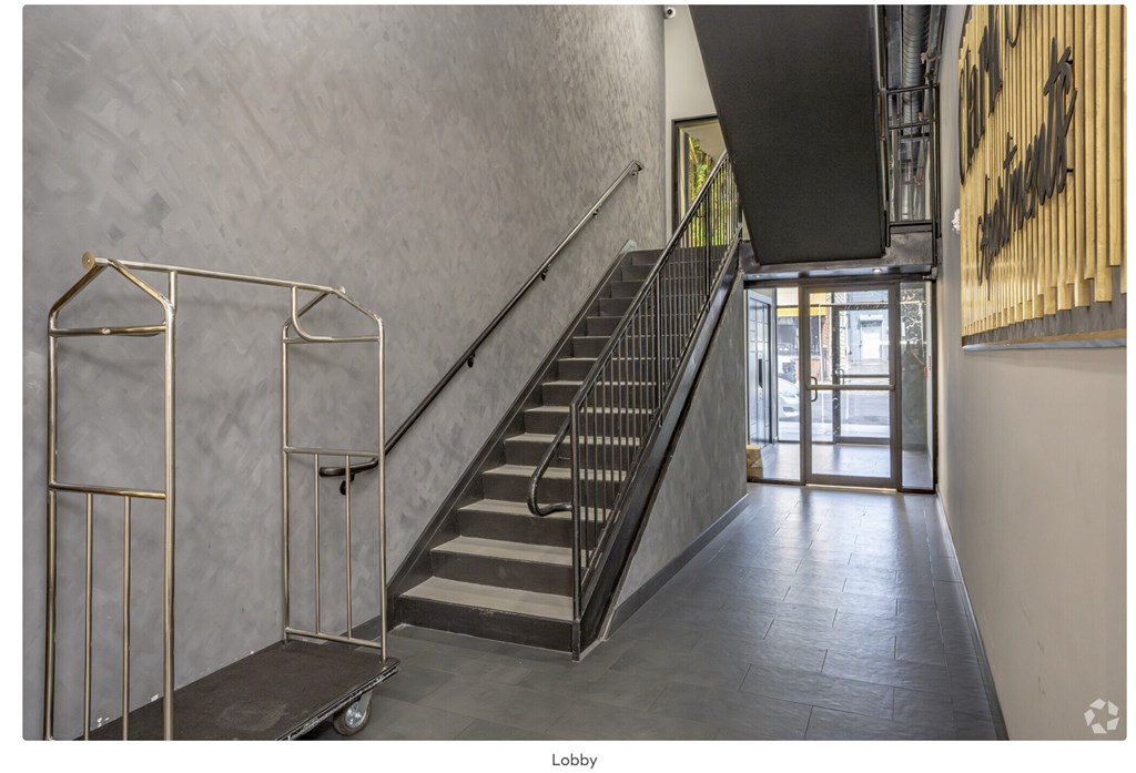 A staircase with a metal railing and a handrail.