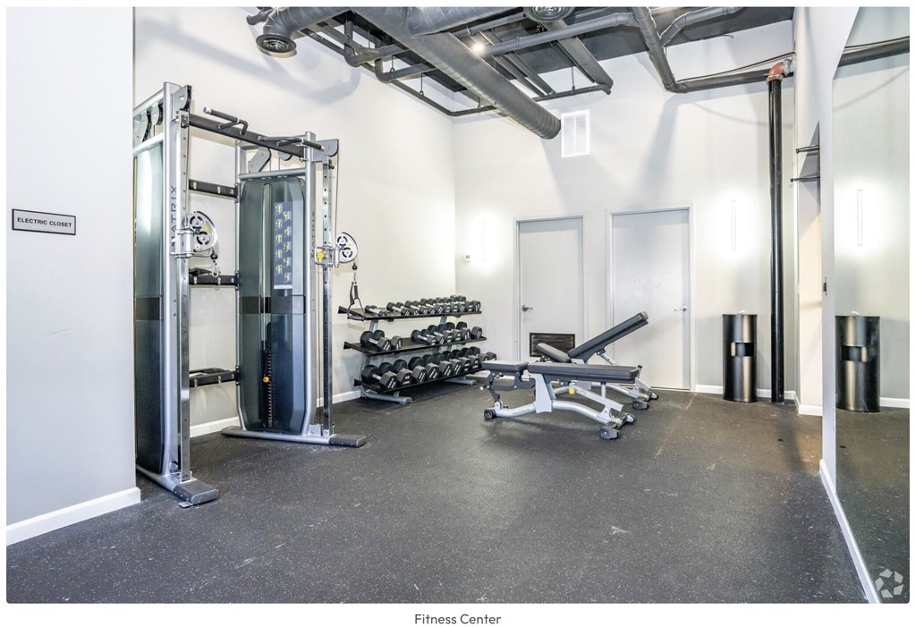 A fitness center with a variety of equipment including a leg press machine.