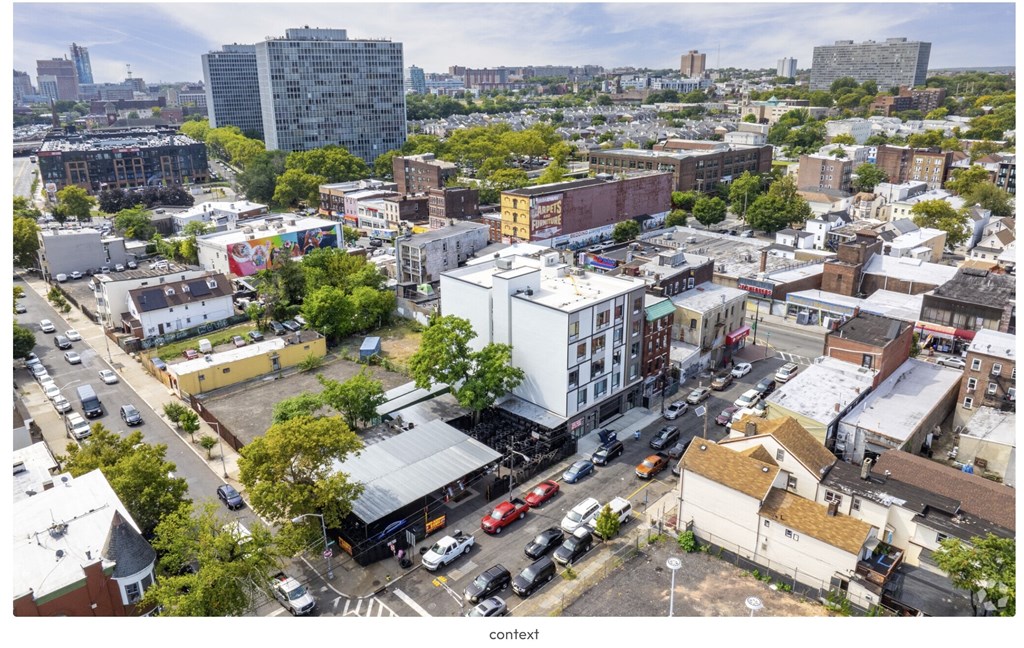 A city street with cars and buildings.