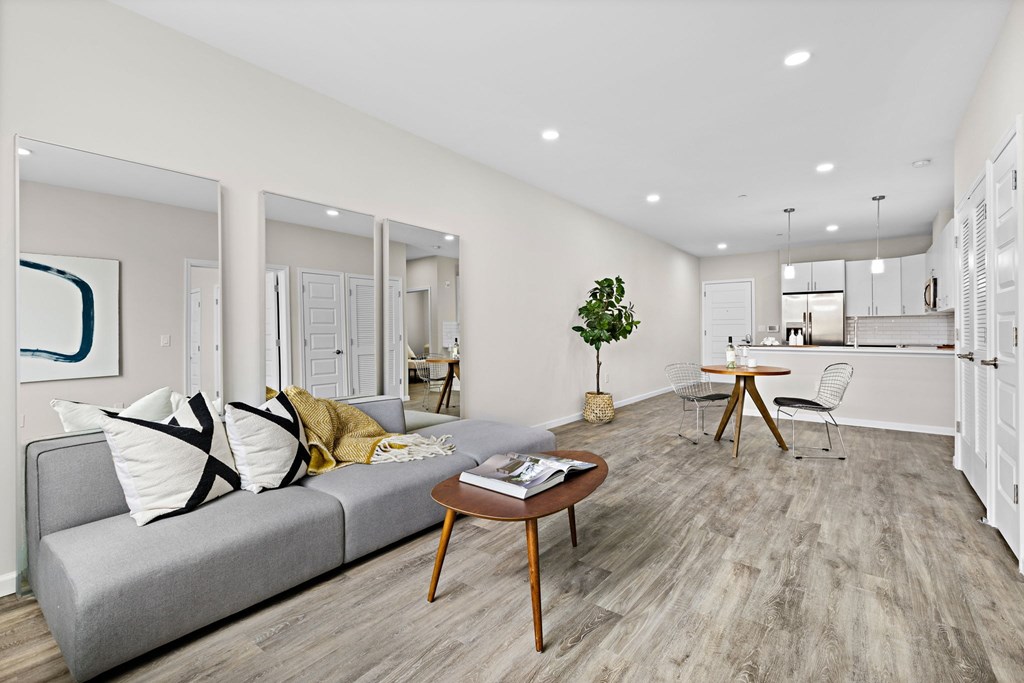 A living room with a grey couch and a wooden coffee table.