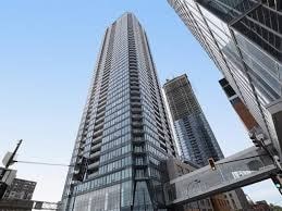 A tall skyscraper stands in a cityscape.