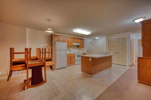 A kitchen with wooden cabinets and a white refrigerator.