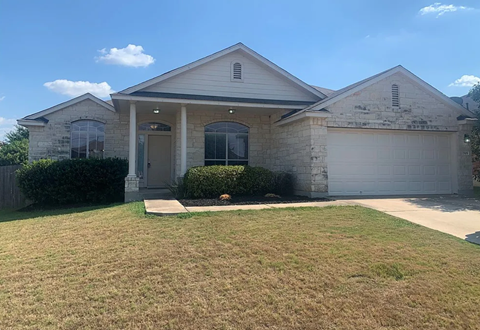 A house with a garage and a front yard.