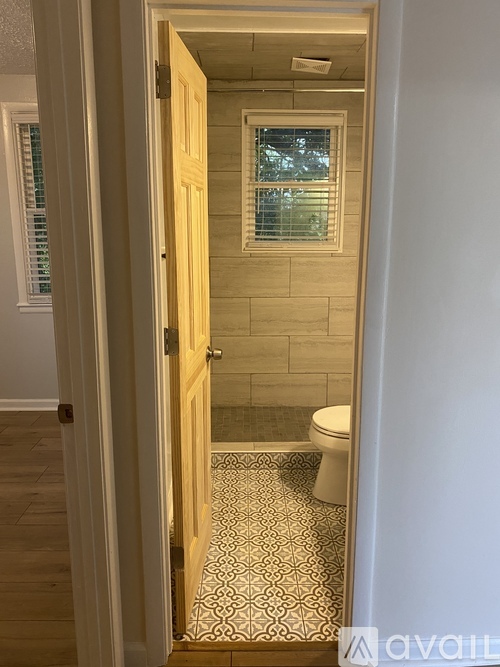 A bathroom with a toilet and a shower.