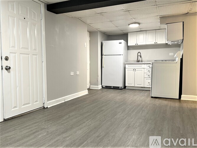 A kitchen with a white fridge and cabinets.