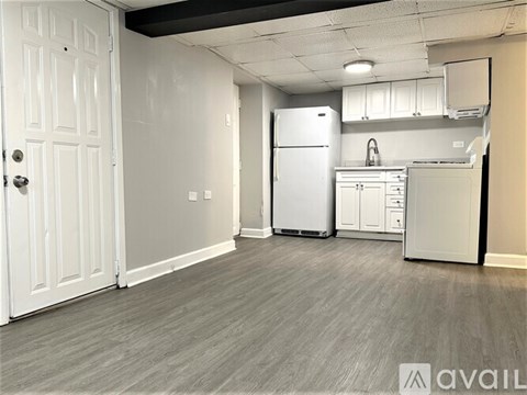 A kitchen with a white fridge and cabinets.