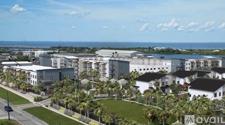 A view of a residential area with houses and palm trees.
