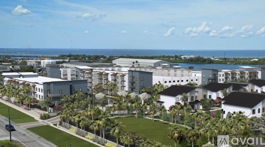 A view of a residential area with houses and palm trees.
