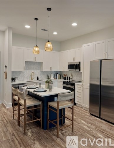 A kitchen with a table and chairs in the middle.