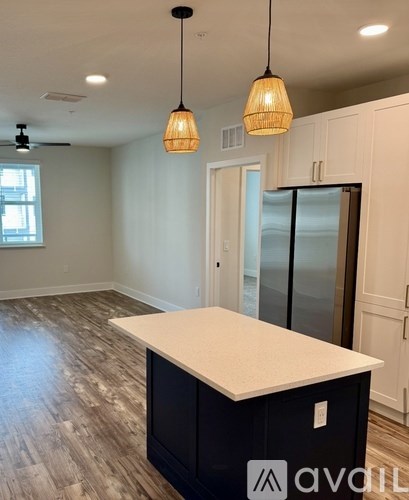 A kitchen with a white countertop and black cabinets.