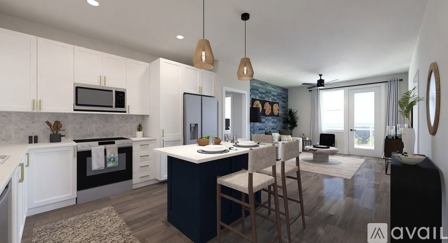 A modern kitchen with a dark blue island and white cabinets.