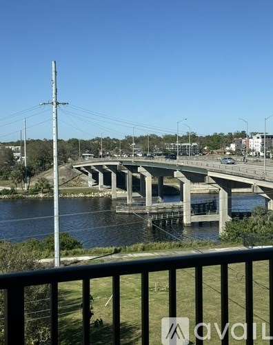 A bridge over a river with a clear blue sky.