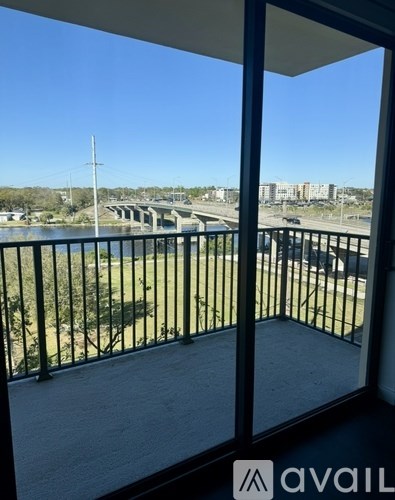A balcony with a view of a bridge and buildings.
